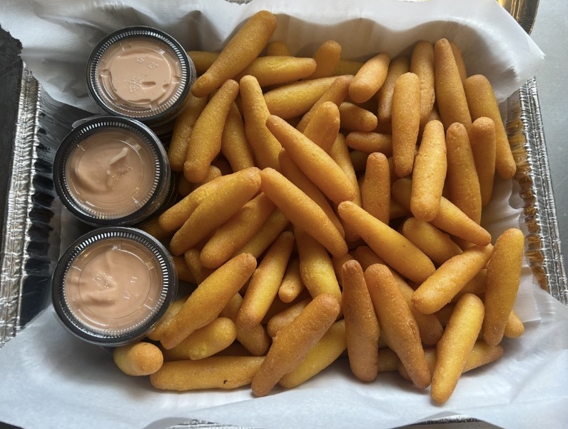 Tray of Puerto Rican sorullitos with dipping sauce