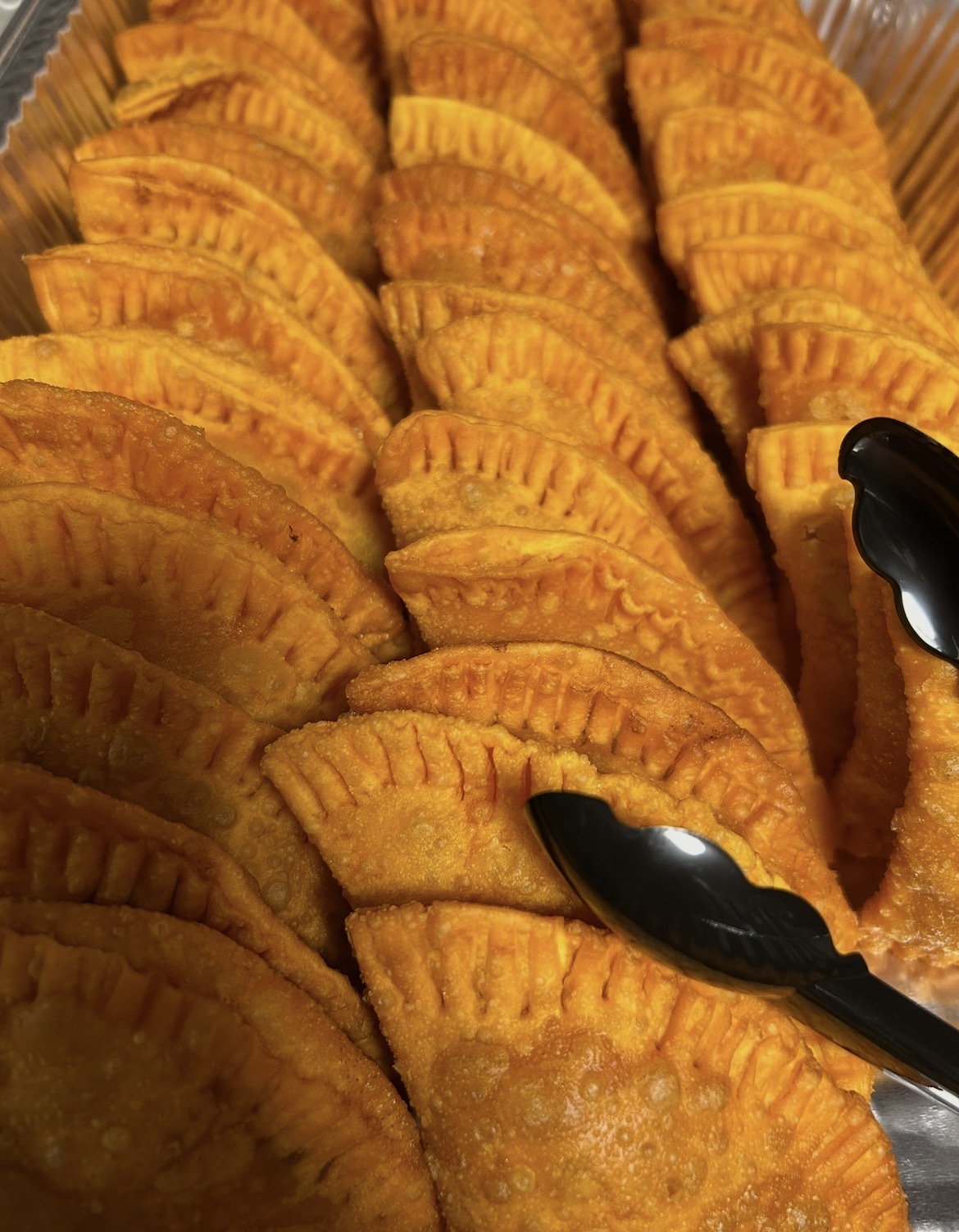 Tray of golden Puerto Rican empanadillas